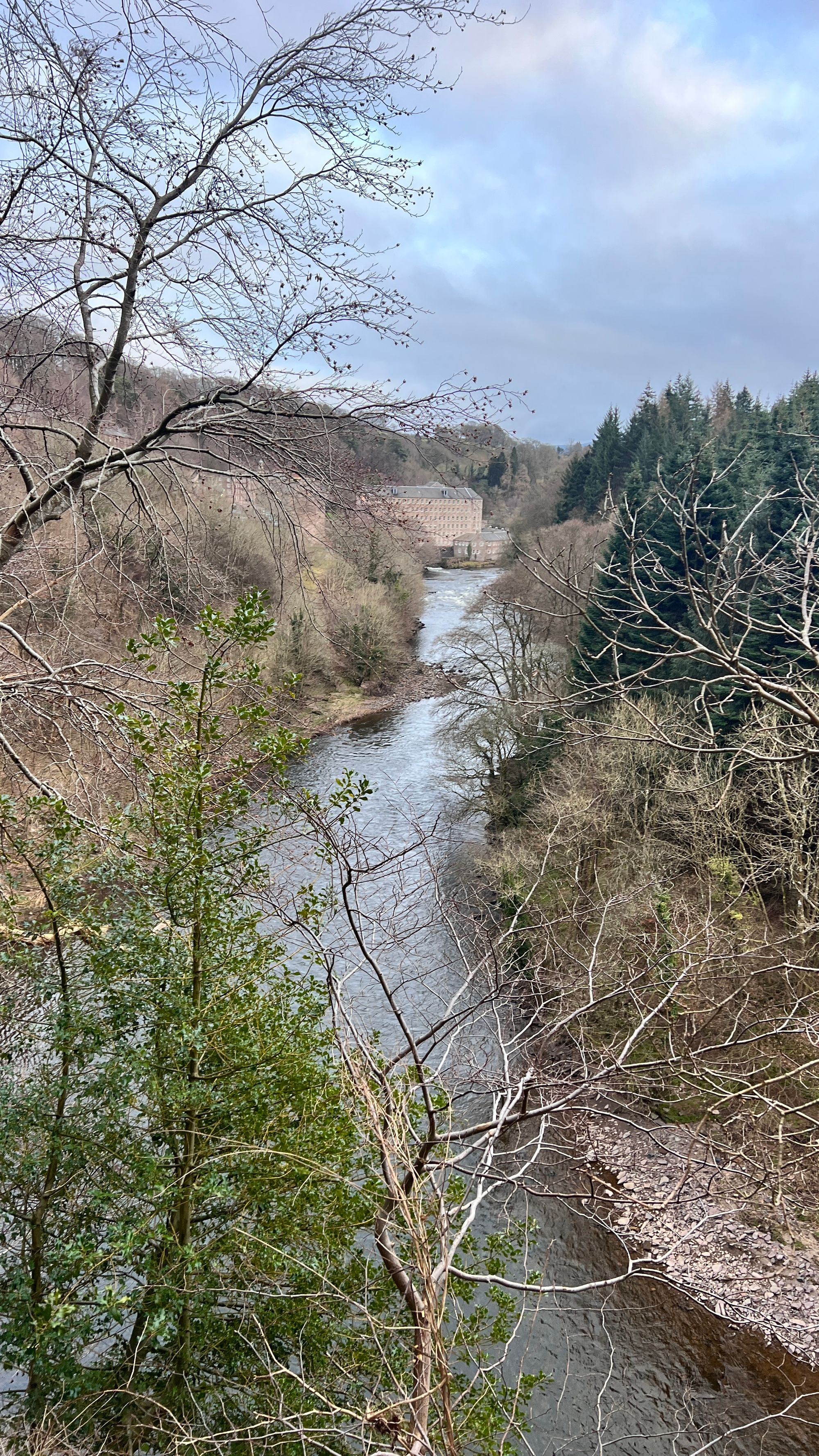 The first view of New Lanark from a viewing platform looking down the River Clyde 